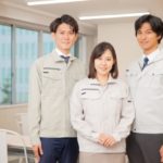 笑顔の作業服の従業員